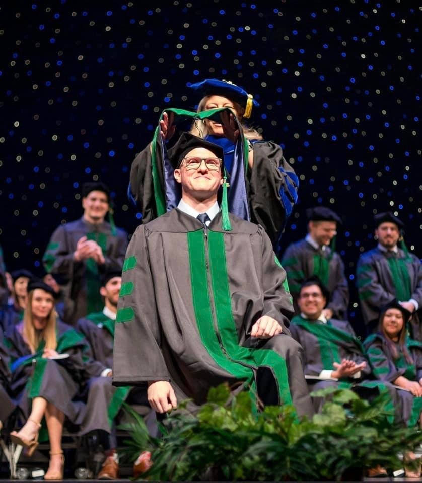 Doc being hooded at his medical school graduation