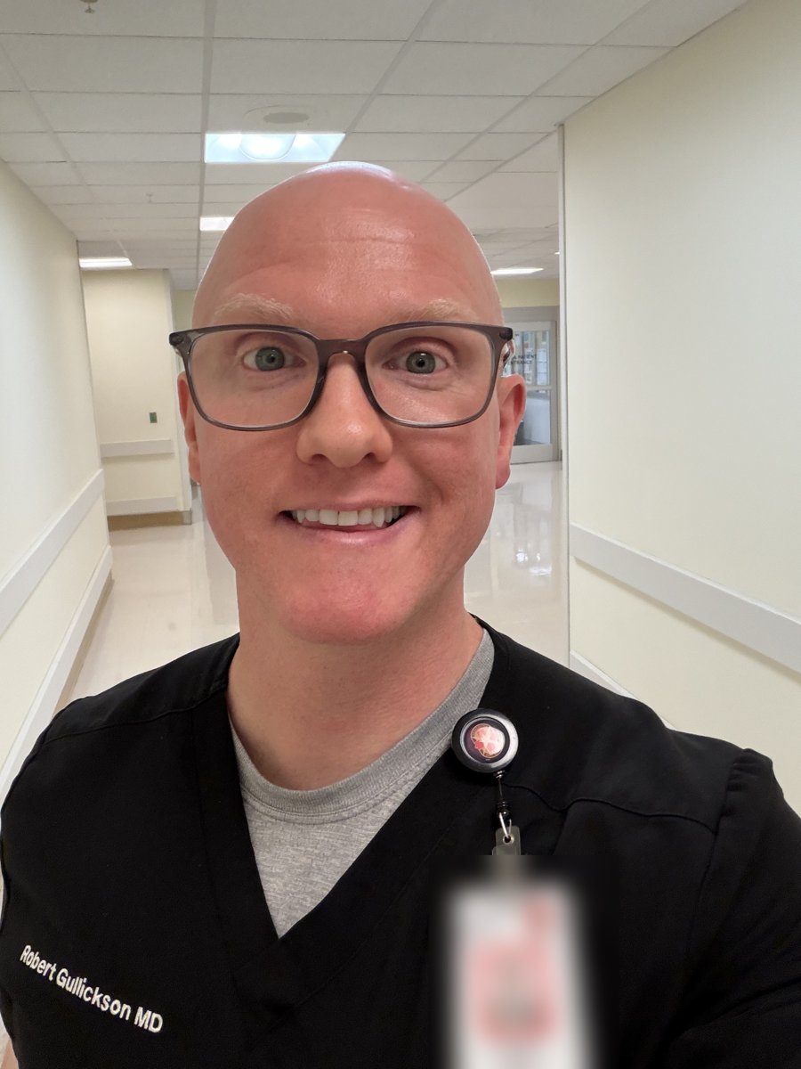 Doc in black scrubs in a hospital hallway