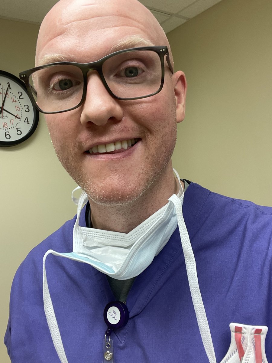 Doc in purple scrubs with a surgical mask
